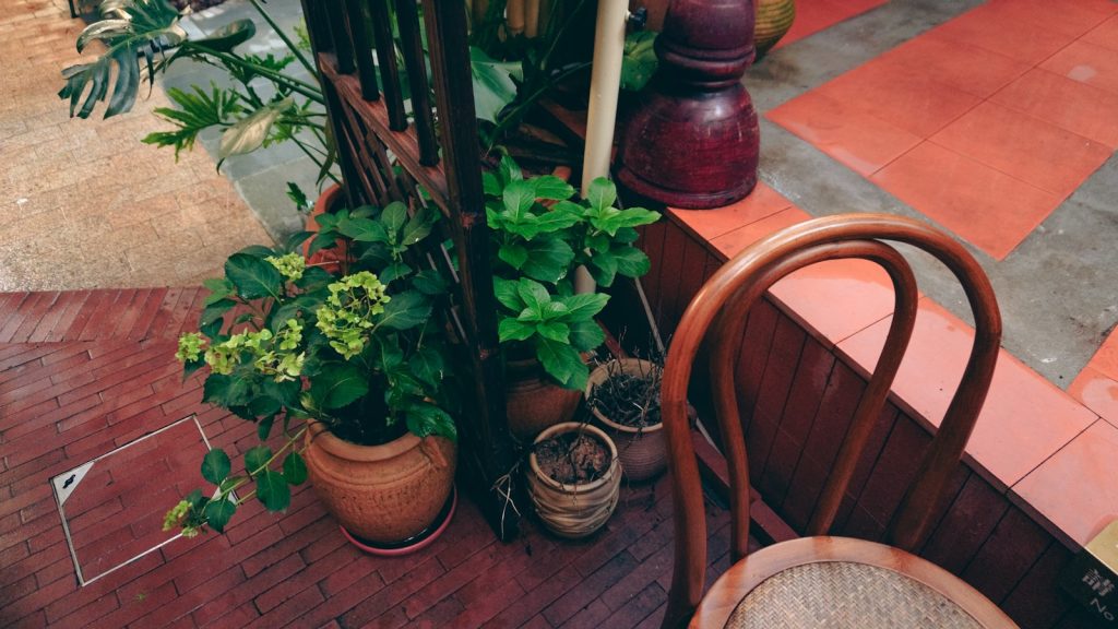 a wooden chair sitting on top of a brick patio